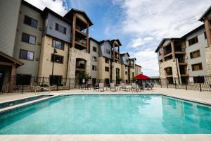 a swimming pool in front of some apartment buildings at Silverado Lodge, Park City - Canyons Village by Vail Resorts in Park City