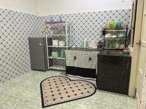 a kitchen with a sink and a tiled floor at Olive Cottage in Marang +10 photos
