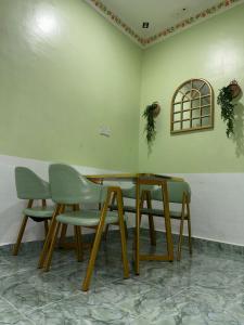 a table and two chairs in a room at Olive Cottage in Marang