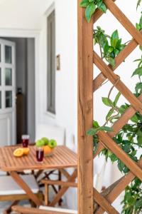 a wooden table with fruits and drinks on it at Casa de Flores 1 in Plaka Milou