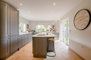 a kitchen with a large clock on the wall at 3 Bed in Syderstone oc-a27669 in Syderstone
