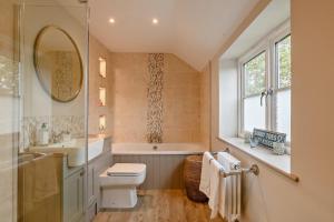 a bathroom with a sink and a toilet and a tub at 3 Bed in Syderstone oc-a27669 in Syderstone +12 photos