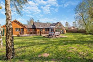a log house with a deck and a yard at 5 Bed in Pentney oc-w27337 in Pentney