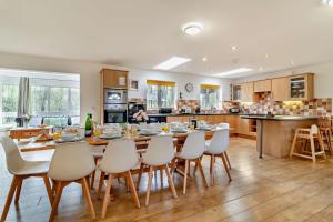 a kitchen and dining room with a table and chairs at 5 Bed in Pentney oc-w27337 in Pentney +11 photos