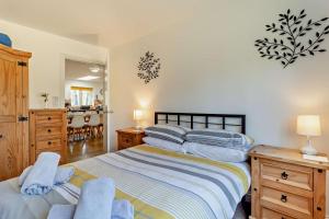 a bedroom with two beds and a dining room at 5 Bed in Pentney oc-w27337 in Pentney