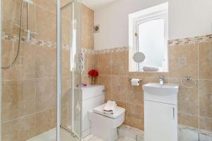 a bathroom with a toilet and a shower at 5 Bed in Pentney oc-w27337 in Pentney