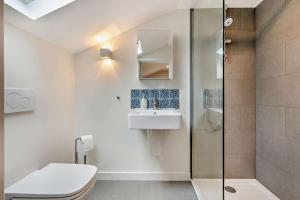 a bathroom with a shower and a toilet and a sink at 1 Bed in Syderstone oc-c29233 in Syderstone +11 photos