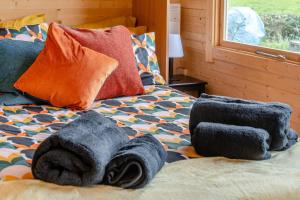 a bed with towels on top of it with a window at 1 Bed in Cilycwm oc-t29297 in Cilycwm