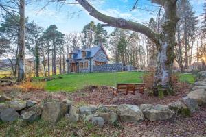 a house on a hill with a bench in front at 3 Bed in Huntly oc-g31733 in Huntly