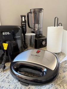 a food processor sitting on a counter next to a blender at Serra Premium Residence in Petrópolis