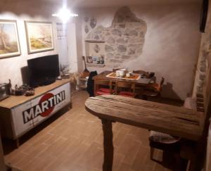 a living room with a table and a television at Il BORGO DEL VENTASSO in Busana