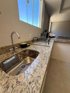 a kitchen with a sink and a counter top at Serra Premium Residence in Petrópolis