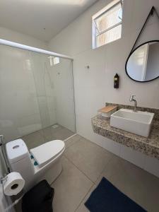 a bathroom with a toilet and a sink at Serra Premium Residence in Petrópolis +12 photos