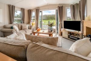 a living room with couches and a flat screen tv at 2 Bed in Sewerby oc-s31941 in Sewerby