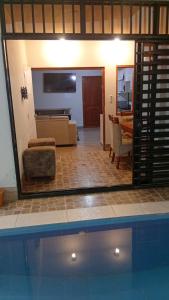 a view of a living room and a swimming pool at Casa Excalibur in Máncora