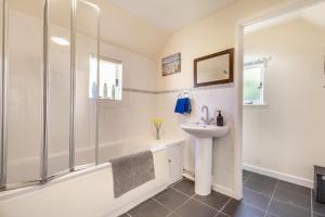 a bathroom with a shower and a sink and a tub at 3 Bed in Stowupland oc-p32216 in Stowmarket +18 photos