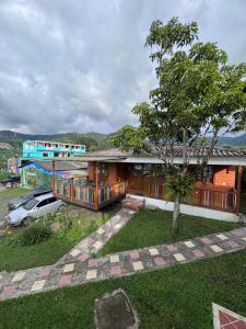 a house with a tree in front of it at Kumanday Lodge in Pereira