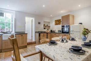 a kitchen with a table with plates and bowls on it at 3 Bed in Southwold oc-rvil in Southwold