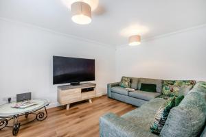 a living room with two couches and a flat screen tv at 5 Bed in St. Bees oc-w32446 in St Bees
