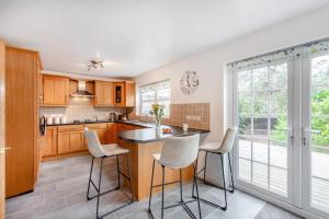 a kitchen with a island with white bar stools at 5 Bed in St. Bees oc-w32446 in St Bees