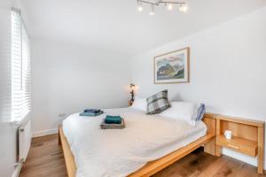 a small bedroom with a bed with white sheets at 5 Bed in St. Bees oc-w32446 in St Bees
