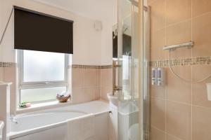 a bathroom with a tub and a shower with a sink at 3 Bed in Corton oc-s32347 in Corton +8 photos