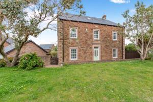 an old brick house with a grass yard at 5 Bed in St. Bees oc-w32446 in St Bees