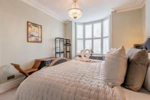a bedroom with a large bed and a chandelier at 6 Bed in Buxton oc-s31063 in Buxton
