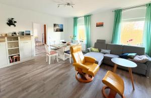 a living room with a couch and a table at Haus Waldblick - Natur pur am Rande des Nationalparks Jasmund in Sassnitz