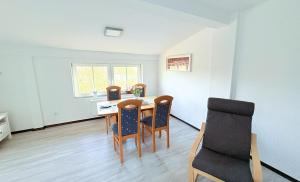 a dining room with a table and chairs at Haus Waldblick - Natur pur am Rande des Nationalparks Jasmund in Sassnitz
