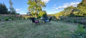 a table and chairs sitting in the grass at Haus Waldblick - Natur pur am Rande des Nationalparks Jasmund in Sassnitz