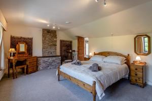 a bedroom with a large bed and a fireplace at 7 Bed in Talgarth oc-h30349 in Talgarth