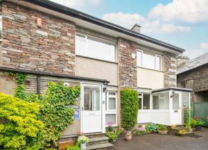 a brick house with white doors and ivy at 2 Bed in Grasmere oc-ld175 in Grasmere