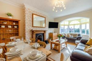 a living room with a table and a fireplace at 3 Bed in Lytham St. Annes oc-m30622 in Saint Annes on the Sea
