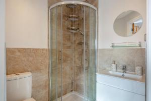 a bathroom with a shower and a toilet and a sink at 3 Bed in Lytham St. Annes oc-m30622 in Saint Annes on the Sea +15 photos