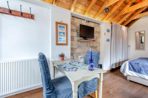 a room with a table and chairs and a bed at 1 Bed in Swanage oc-l30493 in Langton Matravers