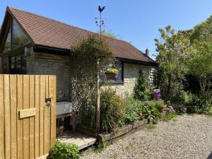 a small house with a bench in the garden at 1 Bed in Swanage oc-l30493 in Langton Matravers