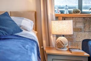 a bedroom with a bed and a lamp on a table at 1 Bed in Swanage oc-l30493 in Langton Matravers