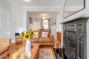 a living room with a vase of sunflowers on a table at 4 Bed in Swanage oc-a29454 in Swanage
