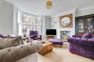 a living room with purple furniture and a tv at 3 Bed in Southwold oc-tlw2 in Southwold