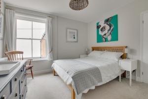 a bedroom with a bed and a desk and a window at 3 Bed in Southwold oc-tlw2 in Southwold