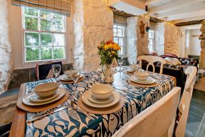 a table with plates and bowls on top of it at 3 Bed in Sennen Cove oc-c29670 in Sennen
