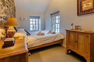 a bedroom with a bed and a desk with a lamp at 3 Bed in Sennen Cove oc-c29670 in Sennen