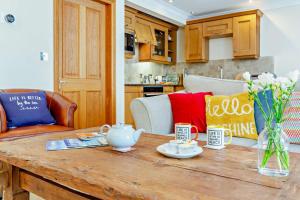 a kitchen with a wooden table with a tea set on it at 1 Bed in Beadnell oc-l29758 in Beadnell