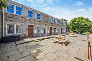 a building with two picnic tables in front of it at 1 Bed in Beadnell oc-l29758 in Beadnell