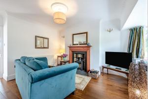 a living room with a blue couch and a tv at 1 Bed in Brynteg oc-g32079 in Llanwenog