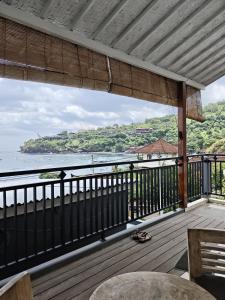 a balcony with a view of the water at Dharma Yoga Homestay dan hostel in Amed