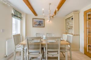 a dining room with a wooden table and chairs at 3 Bed in West Lulworth oc-s32114 in West Lulworth