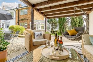a patio with chairs and wine glasses on a table at 3 Bed in Ashbourne oc-e27970 in Ashbourne