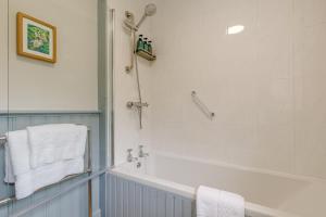 a bathroom with a bath tub and a shower at 3 Bed in Ashbourne oc-e27970 in Ashbourne +31 photos
